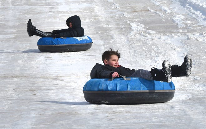 Children enjoy riding the snow hill during Winter Blast in Royal Oak on Saturday, February 19, 2021.