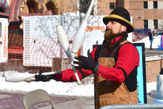 Detroit Circus performer Scott Vasnsice entertains a crowd with his juggling during Winter Blast in Royal Oak on Saturday, February 19, 2021.