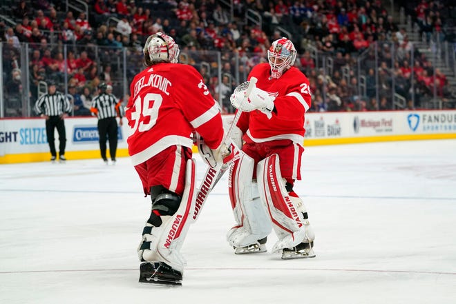 Red Wings goaltender Thomas Greiss, right, replaces Alex Nedeljkovic in the first period of Saturday's game against the Maple Leafs at Little Caesars Arena.