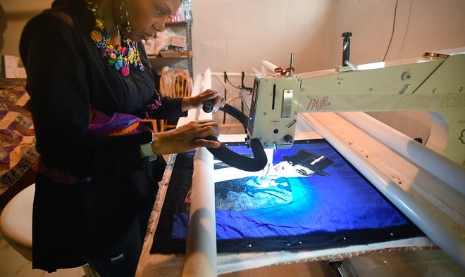 Artist April Anue Shipp works on a piece of art of French entertainer Josephine Baker on a huge embroidery machine at her home, studio.