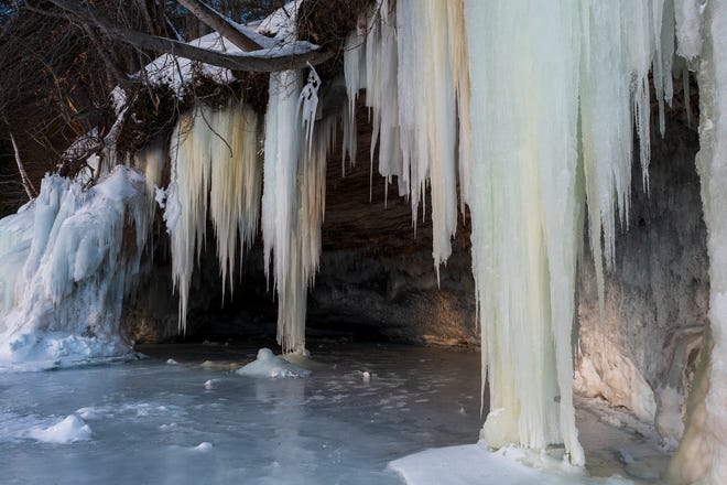 Ice drips down over a cave on Grand Island, in Lake Superior, near Munising, MI., Thursday, March 3, 2022.