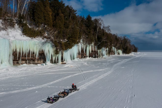 Scott Kuasmirek, owner of Lake Superior Ice Cave Tours, shuttles visitors out to the ice caves on Grand Island, in Lake Superior, near Munising, MI., Thursday, March 3, 2022.