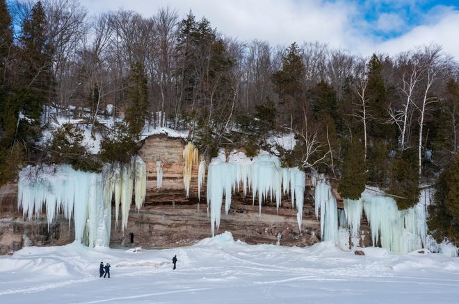 Visitors check out the ice caves on Grand Island, in Lake Superior, near Munising, MI., Thursday, March 3, 2022.