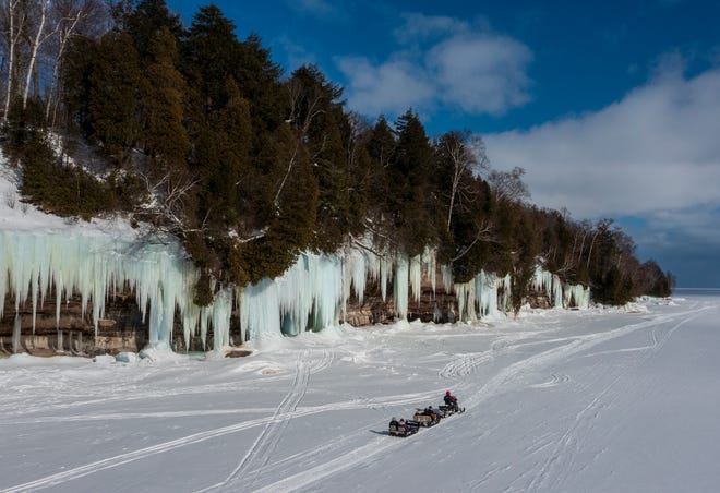 Scott Kuasmirek, owner of Lake Superior Ice Cave Tours, shuttles visitors out to the ice caves on Grand Island, in Lake Superior, near Munising, MI., Thursday, March 3, 2022.