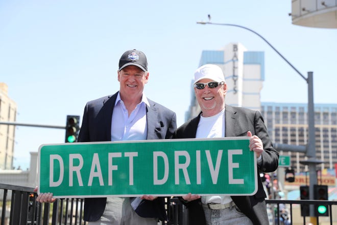 NFL Commissioner Roger Goodell (L) poses with Las Vegas Raiders owner Mark Davis and a Draft Drive ceremonial street sign on Thursday, April 28, 2022, in Las Vegas. The corner of Las Vegas Blvd. and Flamingo was temporarily renamed for the NFL Draft being held April 28-30.