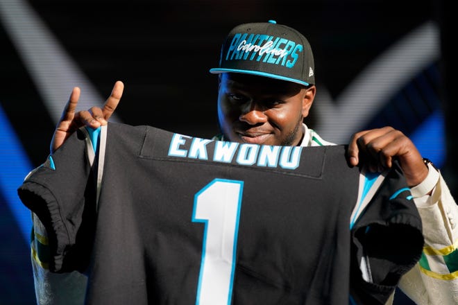 North Carolina State offensive tackle Ikem Ekwonu poses for photos after being picked by the Carolina Panthers with the sixth pick of the NFL football draft.