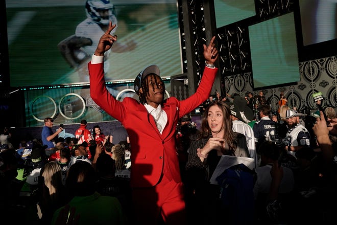 Alabama wide receiver Jameson Williams celebrates after being chosen by the Detroit Lions with the 12th pick of the NFL football draft.