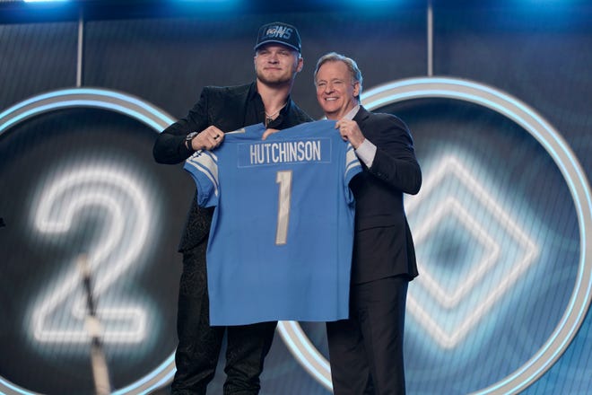 Michigan defensive end Aidan Hutchinson stands next to NFL Commissioner Roger Goodell after being selected by the Detroit Lions as the 2nd pick in the NFL football.