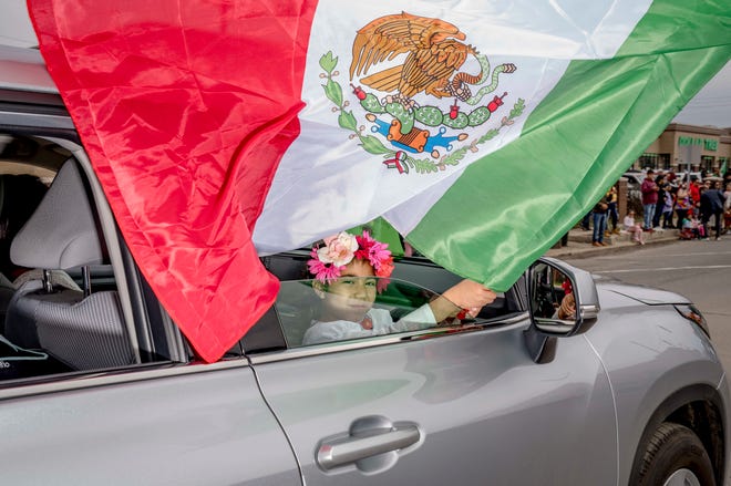 Sophia Hurtado, 5, of Detroit wave a flag of Mexico during the 57th annual Cinco de Mayo Parade in Detroit on May 1, 2022.