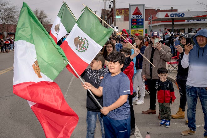 Matias Barco, 12, of Detroit waves a flag of Mexico during the 57th annual Cinco de Mayo Parade in Detroit on May 1, 2022.