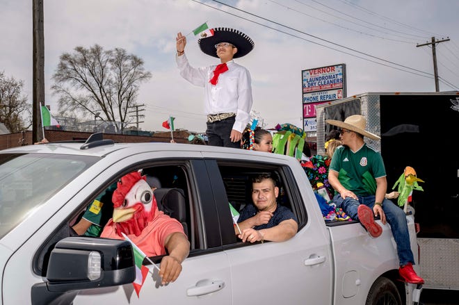 Community members from Les Stanford Chevrolet driver n the parade during the 57th annual Cinco de Mayo Parade in Detroit on May 1, 2022.