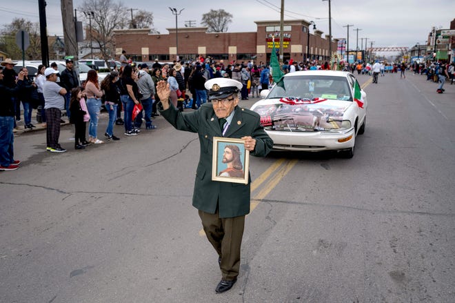 Humberto Oriel of Detroit waves during the 57th annual Cinco de Mayo Parade in Detroit on May 1, 2022.