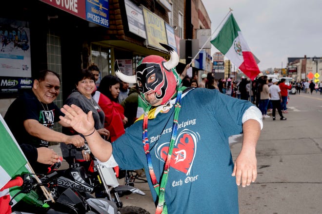 “El Toro,” who did nit provide his real name, high fives people during the 57th annual Cinco de Mayo Parade in Detroit on May 1, 2022.