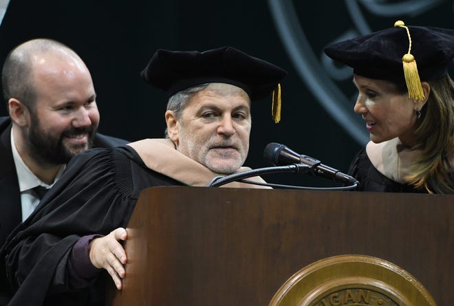 Founder and Chairman of Rocket Companies and Quicken Loans Dan Gilbert, joking about the abundance of the color green at the event, and business leader and philanthropist Jennifer Gilbert receive honorary degrees during the Michigan State University commencement ceremony at the Breslin Center in E. Lansing, Michigan on May 6, 2022.