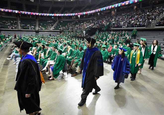 Dignitaries and school officials make their way to the stage during the Michigan State University commencement ceremony at the Breslin Center in E. Lansing, Michigan on May 6, 2022.