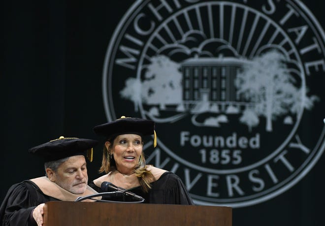 Founder and Chairman of Rocket Companies and Quicken Loans Dan Gilbert and business leader and philanthropist Jennifer Gilbert receive honorary degrees during the Michigan State University commencement ceremony at the Breslin Center in E. Lansing, Michigan on May 6, 2022.
