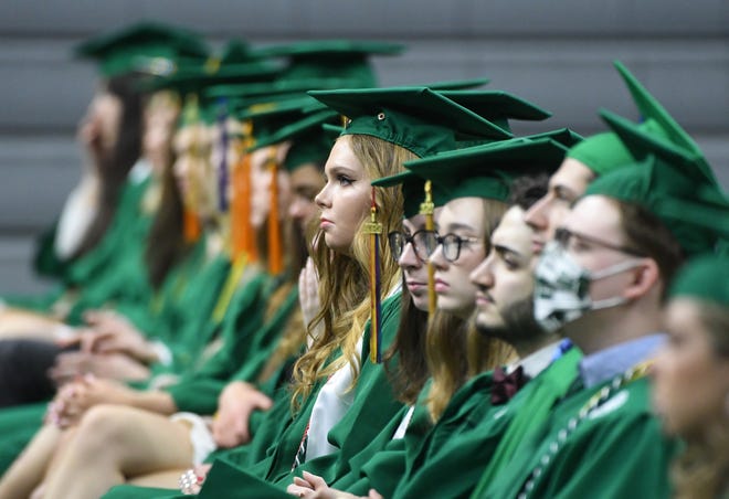 Graduating seniors listen as NBA and MSU basketball star Steve Smith speaks during the Michigan State University commencement ceremony at the Breslin Center in E. Lansing, Michigan on May 6, 2022.