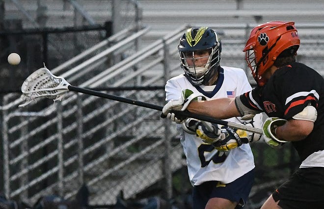 Hartland's Dylan Neuer puts a shot on goal with Brighton's Maxwell Bishop defending in the fourth quarter.
