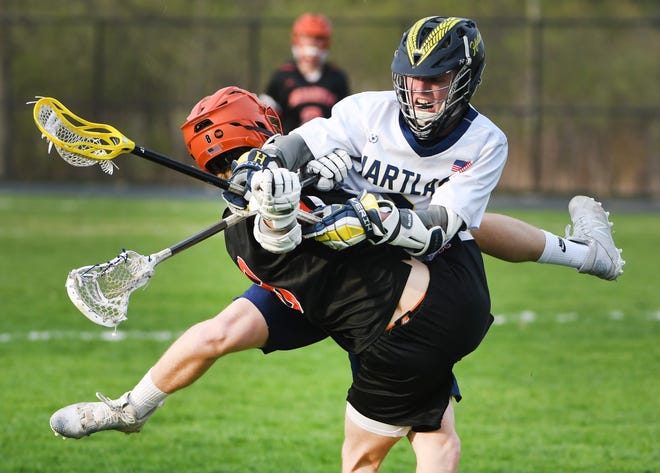 Hartland's Drew Lockwood takes down Brigthon's Jacob Marks in the first quarter of the 18-8 Hartland victory in Hartland, Michigan on May 11, 2022.