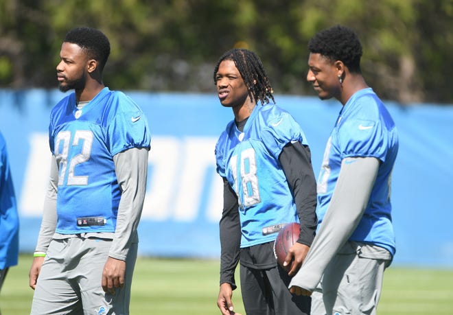 Injured rookies, from left, tight end James Mitchell, wide receiver Jameson Williams and tight end Derrick Deese Jr. on the sidelines during minicamp.