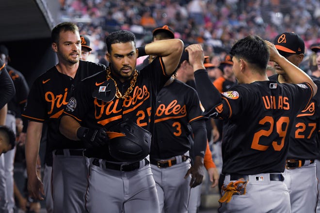 Orioles' Anthony Santander, left foreground, is congratulated by Ramon Urias (29) after Santander hit a home run off Detroit Tigers relief pitcher Jacob Barnes during the eighth inning.