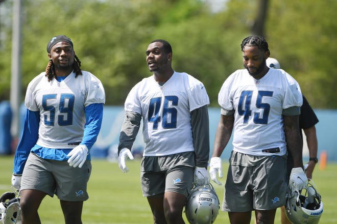 From left, Lions rookie linebacker James Houston, linebacker Jaylan Alexander and linebacker Natrez Patrick leave the field after practice.