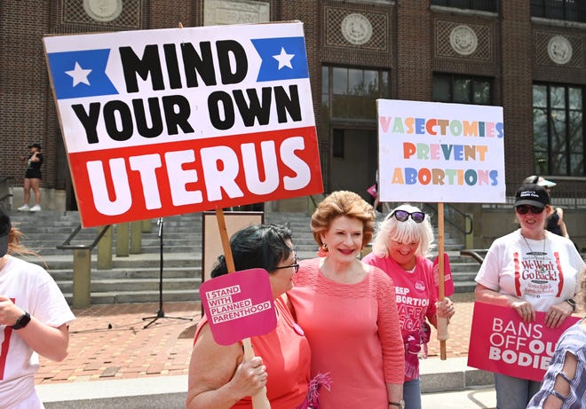 Pam Obriot (left) stands with Sen. Debbie Stabenow and Susan Schissler at planned parenthood rally in Ann Arbor on Saturday, May 14, 2022.