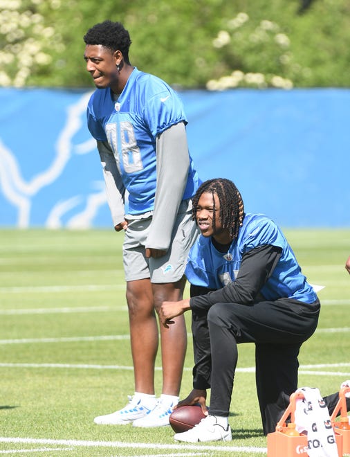 Injured rookies, from left, tight end Derrick Deese Jr. and wide receiver Jameson Williams on the sidelines during minicamp.