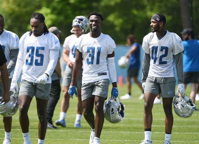 From left, Lions rookie cornerback Cedric Boswell, safety Kerby Joseph and cornerback Jermaine Waller leave the field after minicamp.