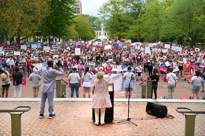 Planned parenthood advocates of Michigan listen to Congresswoman Debbie Dingell (center) as they rally for abortion rights.