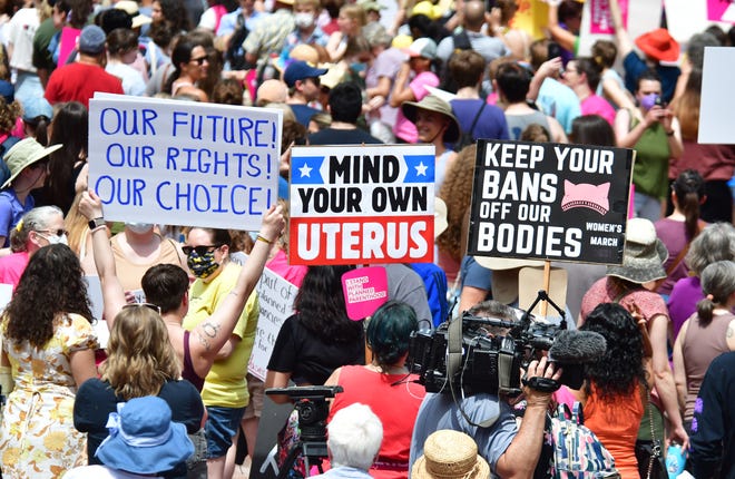 Planned parenthood advocates show their signs in Ann Arbor on Saturday, May 14, 2022.