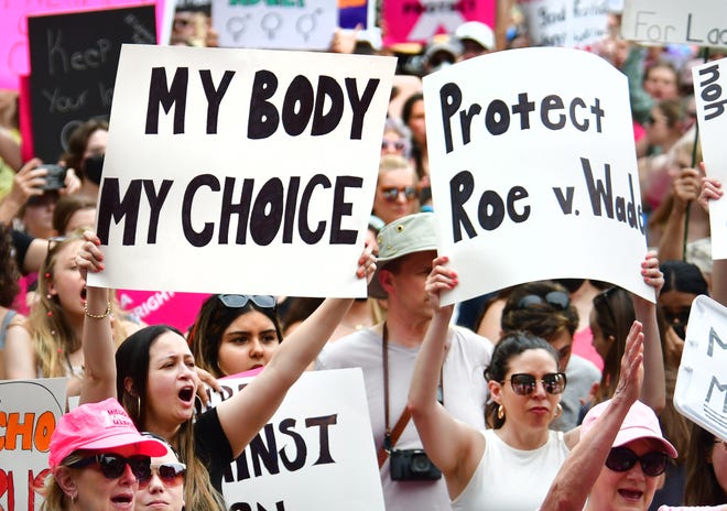 Planned parenthood advocates of Michigan chant and hold signs during a rally in Ann Arbor on Saturday, May 14, 2022.