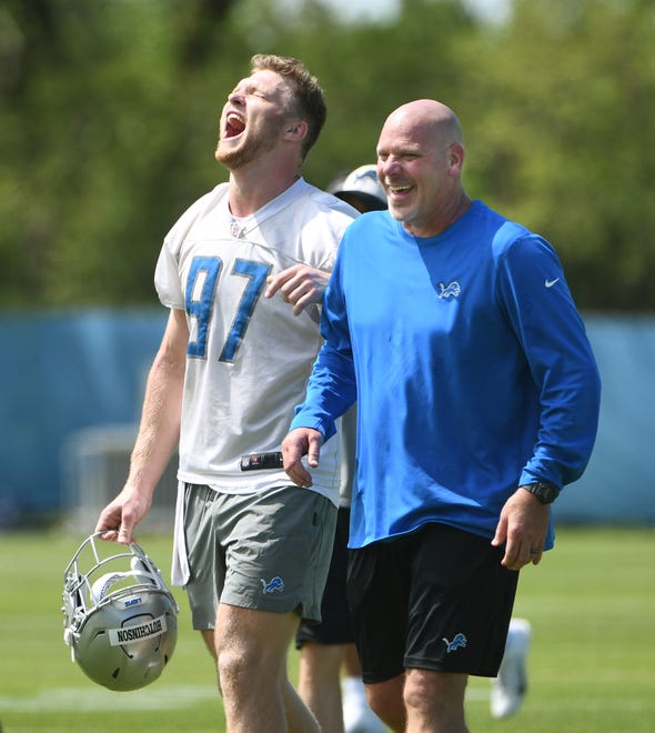 Rookie defensive lineman Aidan Hutchinson shares a laugh with defensive line coach Todd Wash after Detroit Lions rookie minicamp at the training facility in Allen Park on May 14, 2022.