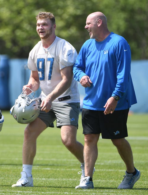 Lions rookie defensive lineman Aidan Hutchinson walks off the field with defensive line coach Todd Wash after minicamp.