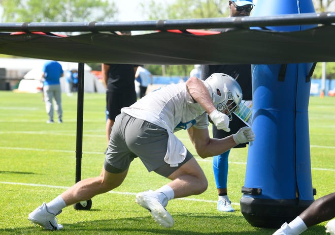 Rookie defensive lineman Aidan Hutchinson works under an obstacle during drills.