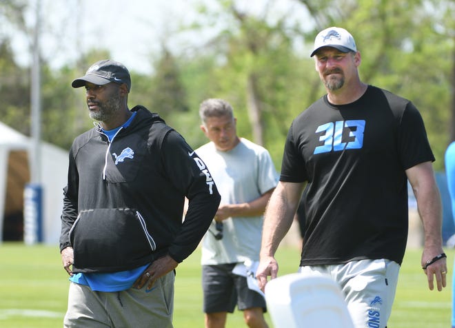 Lions executive vice president and GM Brad Holmes and head coach Dan Campbell leave the field after minicamp.
