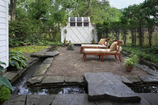 Designer Barry Harrison’s small garden space features an impressive custom moat that houses his prized koi.