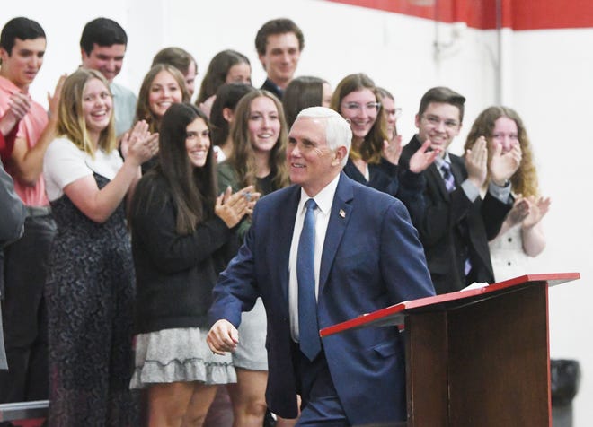 Former Vice President Mike Pence stops and shakes hands with students as he makes his way to the stage at Lutheran High School Northwest, for an assembly about a school of choice tax credit initiative.