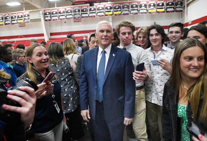 Former Vice President Mike Pence mills with students at private school Lutheran High School Northwest after an assembly about a school of choice tax credit initiative.