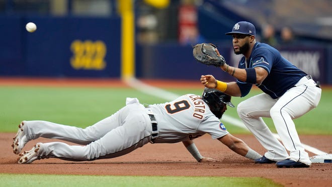 Detroit Tigers' Willi Castro (9) dives back safely to first base ahead of the pick off throw to Tampa Bay Rays' Yandy Diaz during the first inning.