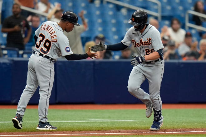 Detroit Tigers' Spencer Torkelson (20) celebrates with third base coach Ramon Santiago (39) after his home run off Tampa Bay Rays relief pitcher Matt Wisler during the seventh inning.