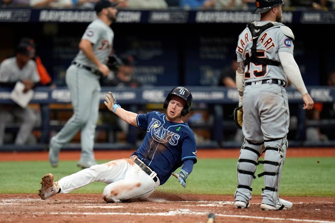 Tampa Bay Rays' Brett Phillips scores behind Detroit Tigers catcher Tucker Barnhart on an RBI single by Ji-Man Choi during the seventh inning.