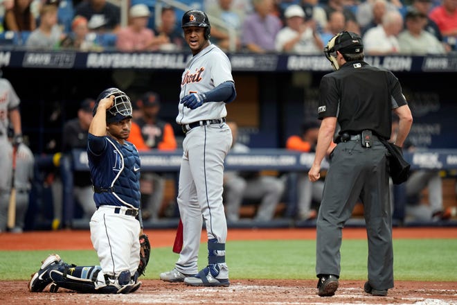 Detroit Tigers' Jonathan Schoop, center, has words for home plate umpire DJ Reyburn, right, after being called out on strikes against Tampa Bay Rays starting pitcher Drew Rasmussen during the fourth inning.