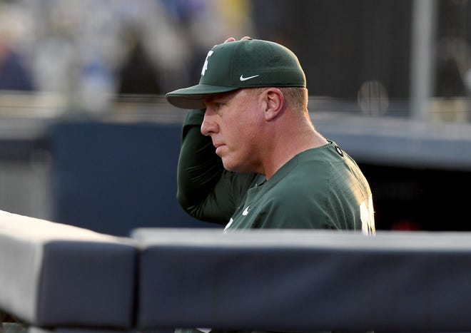 Michigan State head coach Jake Boss Jr. watches the action from the dugout.