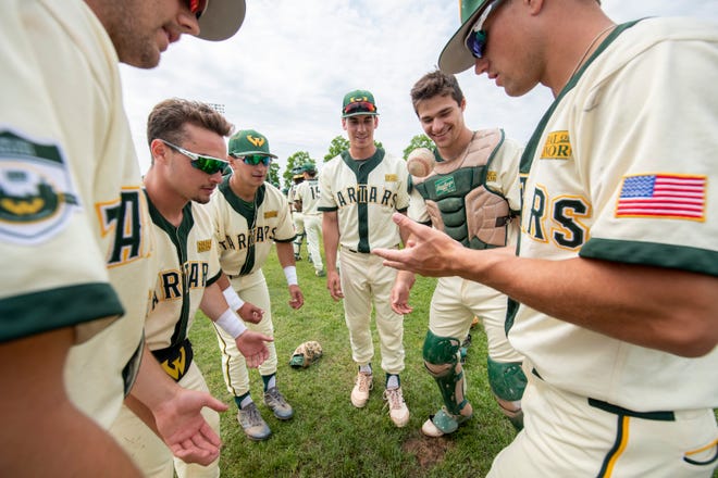 Wayne State baseball players toss the ball to each other before the start of Thursday's NCAA Division II Midwest Regional game against Walsh.