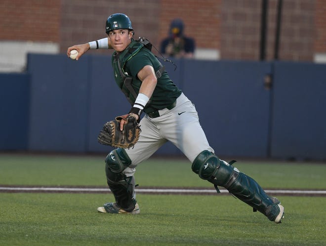 Michigan State catcher Bryan Broecker looks to throw the ball to first after a good bunt by Michigan's Joe Stewart during Michigan's 11-8 win over Michigan State, Tuesday night, May 17, 2022, at Michigan's Ray Fisher Stadium.