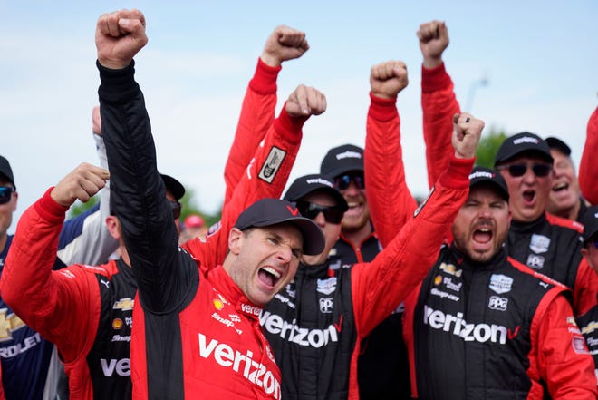 Will Power, left, celebrates with his team after winning the IndyCar Detroit Grand Prix auto race on Belle Isle in Detroit, Sunday, June 5, 2022.