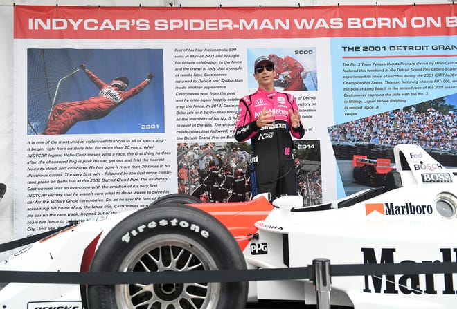 IndyCar driver Helio Castroneves speaks at the Grand Prix legacy tent reunited with his 2000 winning car in the Fan Zone at the Chevrolet Detroit Grand Prix on Belle Isle in Detroit on June 5, 2022.