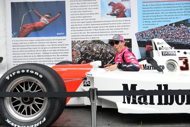 IndyCar driver Helio Castroneves has no trouble fitting into his 2000 winning car at the Grand Prix legacy tent in the Fan Zone at the Chevrolet Detroit Grand Prix on Belle Isle in Detroit on June 5, 2022.