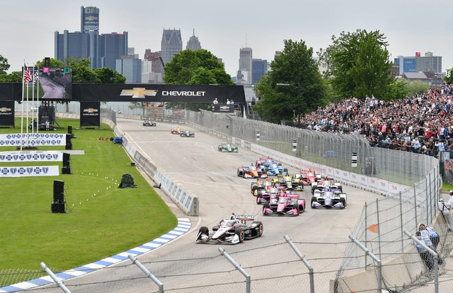 IndyCar racers come around the turn in front of the main grandstand at the start of the Chevrolet Detroit Grand Prix on Belle Isle in Detroit, Sunday.